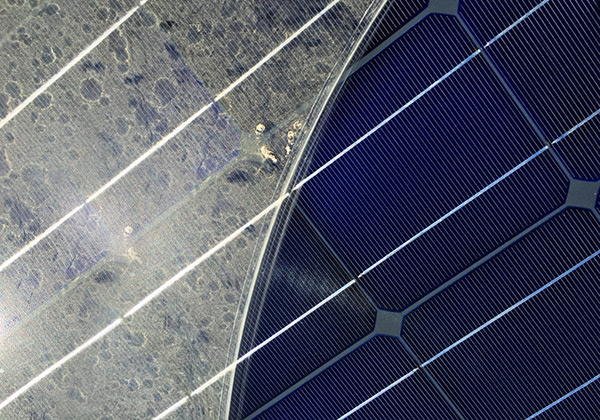 A dirty solar panel being cleaned